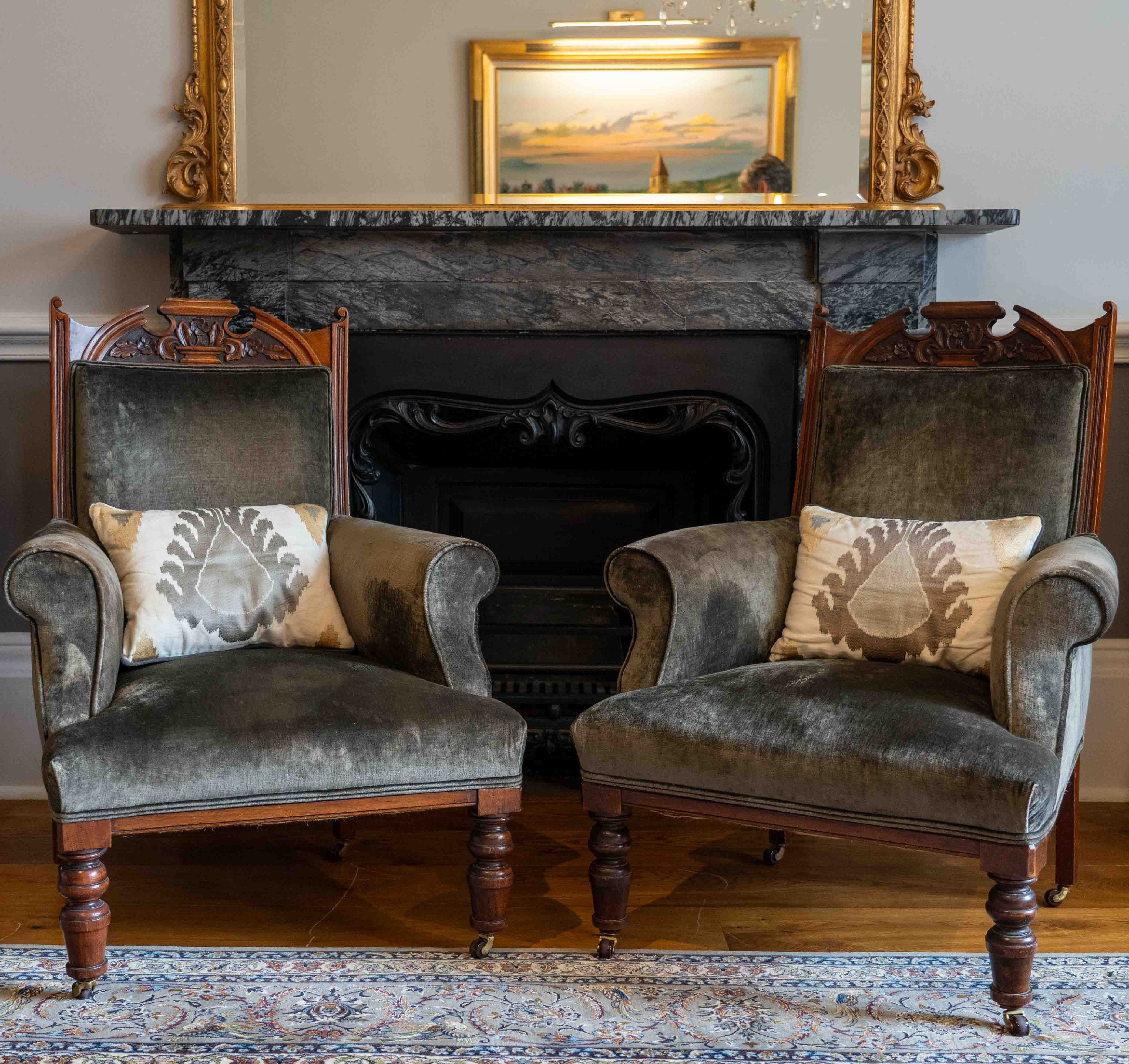 A pair of late Victorian upholstered walnut armchairs, width 73cm, depth 68cm, height 98cm. Condition - fair